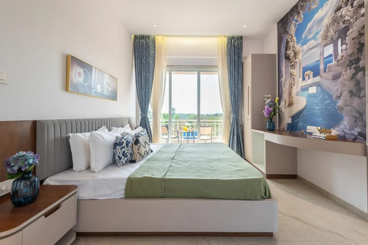 A bedroom with the balcony beyond