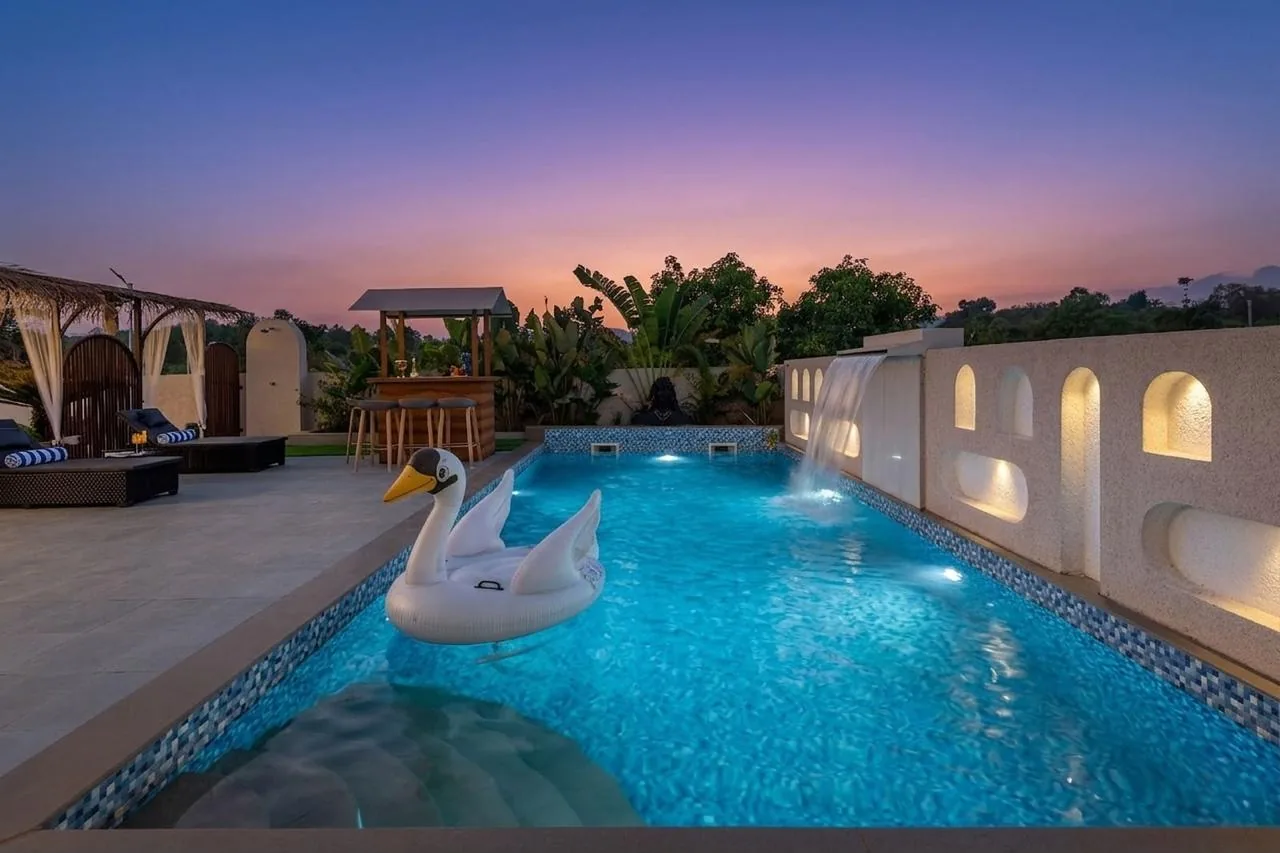 The pool at sunset, the cabana along one side